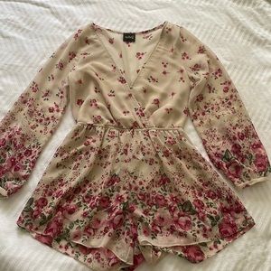 Small audrey romper. Mostly cream with pink and green florals/leaves.
